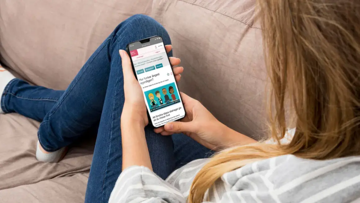 Person läser på mobilen om hur ångest fungerar, kanske för att lära sig mer om kbt ångest.