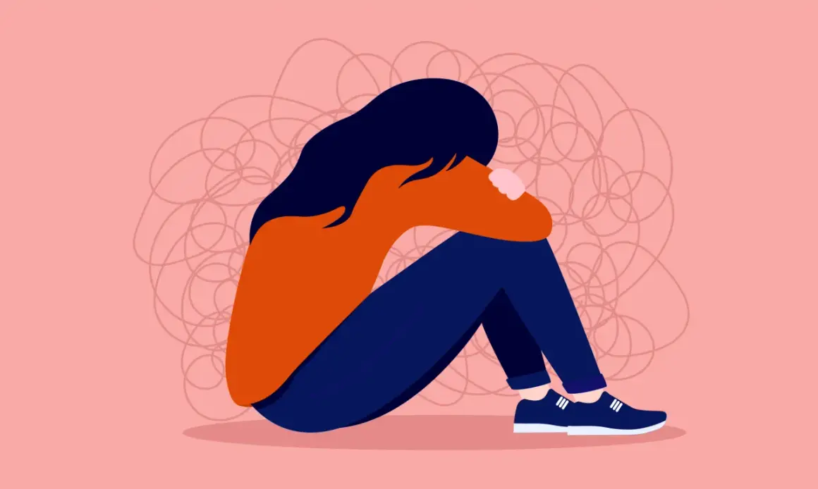 En person sitter hopkrupen, omgiven av trassliga linjer som symboliserar hur det känns när man undrar vad betyder toxic i relationer.