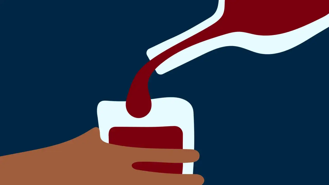 En hand h&aring;ller ett glas medan r&ouml;tt vin h&auml;lls upp. En bild som kan symbolisera alkoholist beteende.