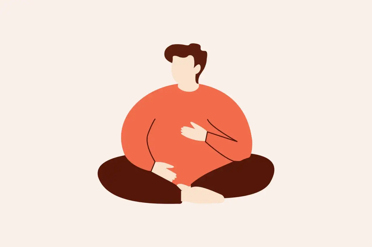 En person sitter i meditationsst&auml;llning, med h&auml;nderna &ouml;ver magen, som om de f&ouml;rs&ouml;ker lugna en k&auml;nsla av konstant &aring;ngest.